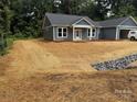 Charming single-story home with a blue exterior, white trim, and a freshly mulched front yard at 415 Dogwood Ln, Statesville, NC 28625