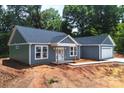 New construction featuring gray siding and white trim, with a two-car garage at 415 Dogwood Ln, Statesville, NC 28625