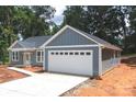 Beautiful home featuring a two-car garage, gray siding, and landscaped front yard at 415 Dogwood Ln, Statesville, NC 28625