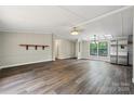 Inviting living room with updated flooring, neutral walls, and large windows offering plenty of light at 5001 Grand Canyon Nw Rd, Concord, NC 28027