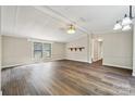 Living room featuring neutral decor, updated flooring and plenty of natural light from the nearby windows at 5001 Grand Canyon Nw Rd, Concord, NC 28027