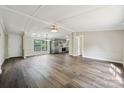 Open-concept living room with modern flooring, new paint, and an airy, sunlit atmosphere at 5001 Grand Canyon Nw Rd, Concord, NC 28027