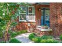 Welcoming brick entryway with a stone walkway, decorative plants, and a stylish front door at 510 Wiley Ave, Salisbury, NC 28144