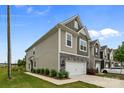 Charming townhouse with stone accents, two-car garage, neutral siding, and professionally landscaped yard at 5207 Maynard Hill Dr, Monroe, NC 28110