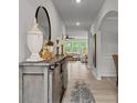 Bright hallway with wood floors leading to the living room, with a decoratively styled console at 5581 Soft Shell Dr, Lancaster, SC 29720