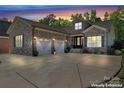 Beautiful brick home featuring a two-car garage and well-maintained landscaping at dusk at 6010 Albiza Dr, Harrisburg, NC 28075