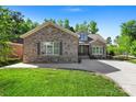 Charming brick home with a well-manicured lawn and mature trees in a nice neighborhood at 6010 Albiza Dr, Harrisburg, NC 28075