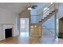 Open-concept living room features hardwood floors, a fireplace, and a grand staircase with large windows at 6020 Gray Gate Ln # I, Charlotte, NC 28210