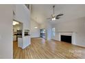 Spacious living area featuring hardwood floors, a fireplace, and an open view of the kitchen at 6020 Gray Gate Ln # I, Charlotte, NC 28210