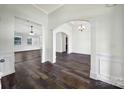Bright living area featuring new hardwood flooring, white walls, and arched doorways with elegant trim at 6021 Piscataway Ct, Rock Hill, SC 29732