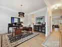 Elegant home office with hardwood floors, wainscoting, stylish lighting and sophisticated decor at 6309 Wakehurst Rd, Charlotte, NC 28226