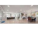 Open-concept living space with modern lighting, light wood floors, and direct access to the kitchen at 685 Knollcrest Ne Dr, Concord, NC 28025