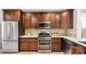 Spacious kitchen featuring stainless steel appliances, ample counter space, and dark wood cabinets at 7324 Jolly Brook Dr, Charlotte, NC 28215