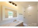 Modern bathroom featuring a vanity with marble countertop and a tiled walk-in shower at 7426 Hambright Rd, Huntersville, NC 28078