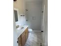Modern bathroom with white subway tiles in shower, marble floors and wooden vanity with marble top at 7426 Hambright Rd, Huntersville, NC 28078