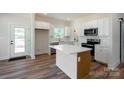 Bright, stylish kitchen with white cabinets, a large island, and stainless steel appliances at 7426 Hambright Rd, Huntersville, NC 28078