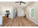 Bright living area featuring wood floors, modern lighting, and a barn door at 7426 Hambright Rd, Huntersville, NC 28078