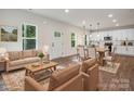 This living room is staged with comfortable seating and connects the kitchen and dining area at 746 Shasta Nw St, Concord, NC 28027