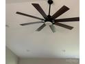 A modern ceiling fan with dark wooden blades is installed in the ceiling of the home at 8222 Madison Ln, Hickory, NC 28602