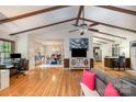 Spacious living room with vaulted ceilings, wood beams, hardwood floors, and open layout at 8544 Houston Ridge Rd, Charlotte, NC 28277