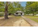 Charming single-story home with a covered porch, walkway, and mature trees at 10 Bolt Dr, Shelby, NC 28150