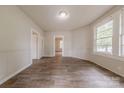 Bright living room with wood-look floors, wainscoting, and abundant natural light at 10 Bolt Dr, Shelby, NC 28150