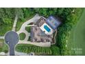 An aerial view displays a beautiful home with a pool, tennis court, and professionally landscaped backyard at 1118 Seminole Dr, Fort Mill, SC 29707