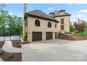 Home exterior features a basketball court, and a three-car garage with a retaining wall at 1118 Seminole Dr, Fort Mill, SC 29707