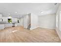 Bright, open-concept living area featuring wood-look floors and modern, neutral decor at 1411 Duhart Ave, Gastonia, NC 28054