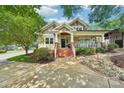 Attractive home featuring manicured landscaping, stone accents and a welcoming front porch perfect for relaxing at 1701 Dearmon Dr, Charlotte, NC 28205