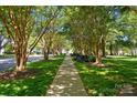Beautiful tree lined street with sidewalk and well manicured lawns at 17130 Bridgeton Ln, Huntersville, NC 28078