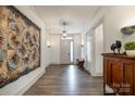 Inviting foyer with natural light, wood floors, and stylish decor to welcome you at 19031 Brandon James Dr, Cornelius, NC 28031
