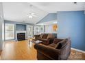 Cozy living room with vaulted ceilings, fireplace, wood floors, and comfortable seating at 2432 Barkers Ridge Dr, Bessemer City, NC 28016