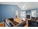 Bright living room with vaulted ceilings, wood floors, a fireplace, and comfortable seating at 2432 Barkers Ridge Dr, Bessemer City, NC 28016
