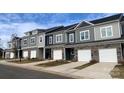 Modern townhome row showcases stylish exteriors, with stone accents and eye-catching color schemes and attached garages at 2535 Ruby Dixon Crossing Dr # 19, Gastonia, NC 28056