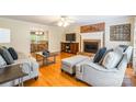 Cozy living room featuring hardwood floors, brick fireplace, and comfortable seating area at 2730 Tiffany Dr, Rock Hill, SC 29732