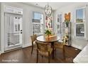 Cozy dining area with wood floors, chandelier lighting, and lots of natural light at 3009 Loso Ter # 58, Charlotte, NC 28217