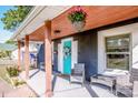Inviting front porch seating area with a bright blue door, hanging flower baskets, and a cozy outdoor vibe at 310 Patterson Ave, Mooresville, NC 28115