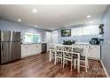 Spacious kitchen with white cabinets, stainless steel appliances, and a dining area perfect for Gathering meals at 310 Patterson Ave, Mooresville, NC 28115