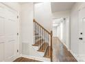 Inviting foyer features wood-look floors, white trim, and a staircase with wrought iron accents at 3101 Willowbrae Rd, Charlotte, NC 28226