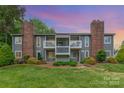 Charming condominium exterior featuring a well-maintained lawn, beautiful landscaping, and brick chimney perfect for relaxing and outdoor enjoyment at 3201 Heathstead Pl # C, Charlotte, NC 28210