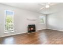 Inviting living room featuring hardwood floors, a decorative fireplace, and large windows that provides a warm and inviting space at 3201 Heathstead Pl # C, Charlotte, NC 28210
