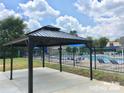 Community pool area with gazebo, lounge chairs, and a blue sky, perfect for relaxing, swimming, and social gatherings at 3201 Heathstead Pl # C, Charlotte, NC 28210