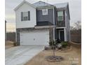 Two-story home with gray and white siding, stone accents, and a two-car garage at 345 Hyssop Ct, Fort Mill, SC 29715