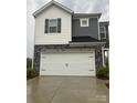 Front exterior of a two-story home with a white garage door and stone accents at 345 Hyssop Ct, Fort Mill, SC 29715