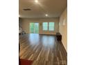 Bright, open living room with wood floors and natural light from sliding glass door at 345 Hyssop Ct, Fort Mill, SC 29715