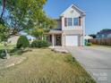 Attractive two-story house featuring a well-kept lawn, attached garage, and charming front porch at 417 Homestead Ln, Albemarle, NC 28001