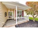 Inviting covered front porch with stone flooring, ideal for relaxing and enjoying the outdoors with potted plants at 422 Garnet Ct, Fort Mill, SC 29708