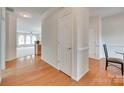 Open hallway with hardwood floors leading to the living room, offering a seamless flow throughout the home at 422 Garnet Ct, Fort Mill, SC 29708