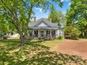 This single Gathering house has a covered front porch with stone pillars and a well-manicured lawn at 4960 York Hwy, Rock Hill, SC 29732